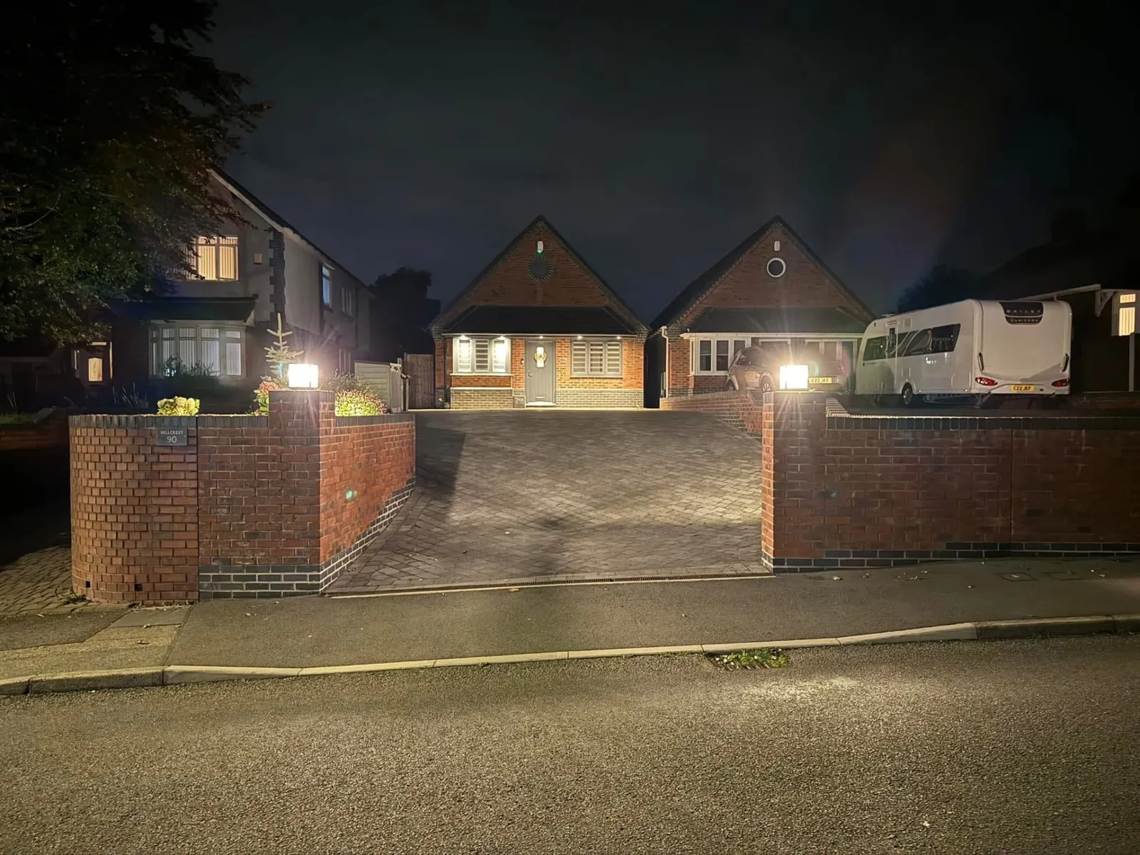 Completed block paved driveway with lighting and brick boundary walls built by Stret Limited groundworkers
